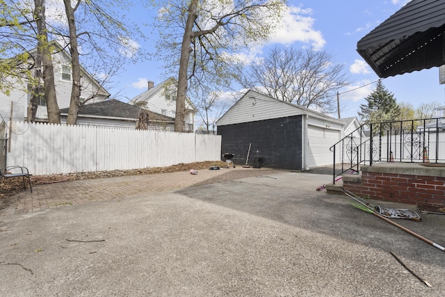 exterior space featuring fence and concrete driveway