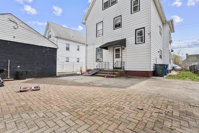 back of house with fence and a patio