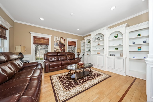 living room featuring recessed lighting, crown molding, and light wood-style flooring