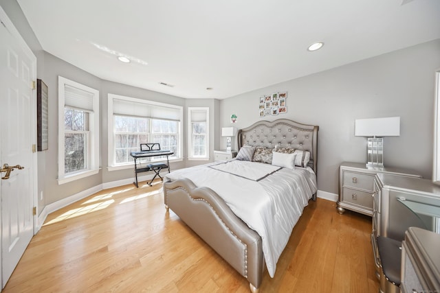 bedroom featuring recessed lighting, visible vents, light wood finished floors, and baseboards
