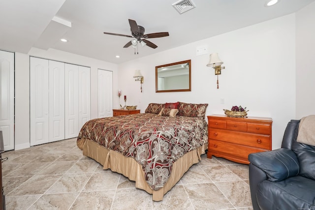bedroom with multiple closets, ceiling fan, stone finish flooring, visible vents, and recessed lighting