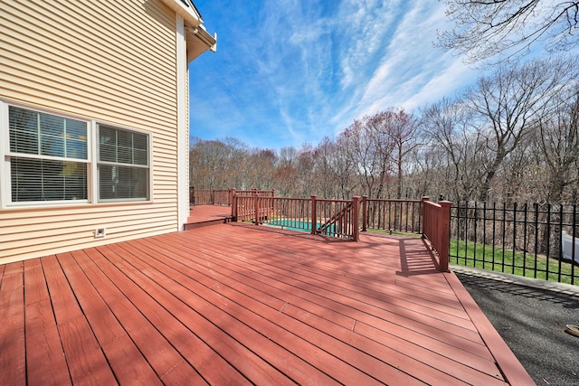 wooden terrace featuring fence