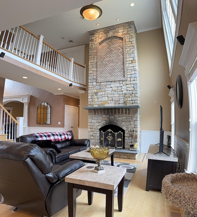 living area featuring a high ceiling, a fireplace, and plenty of natural light