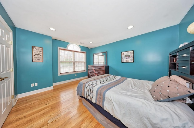 bedroom featuring baseboards, recessed lighting, and wood finished floors