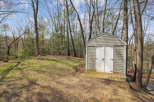 view of shed with a forest view
