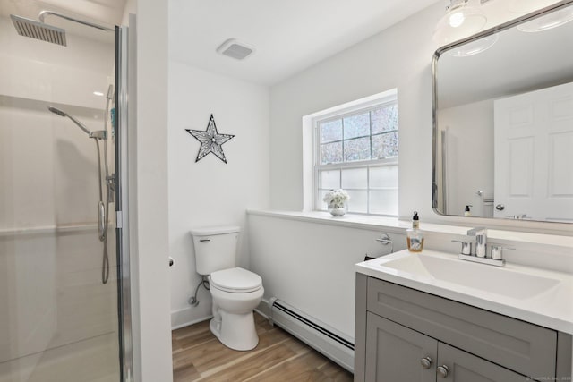 bathroom with toilet, baseboard heating, wood finished floors, and a stall shower