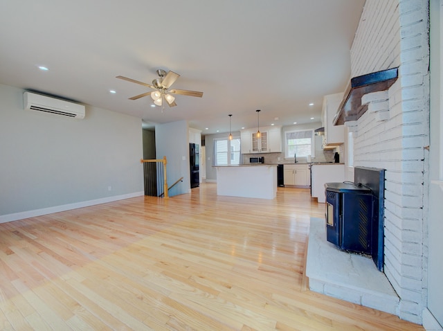 10 Versailles Rd, Lisbon, CT 06351 - unfurnished living room featuring recessed lighting, a wall mounted air conditioner, a ceiling fan, a sink, and light wood-style flooring