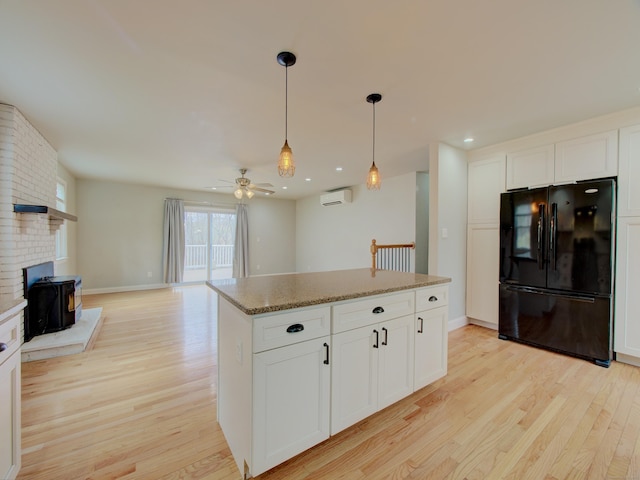 10 Versailles Rd, Lisbon, CT 06351 - kitchen featuring ceiling fan, light wood-style flooring, hanging light fixtures, and freestanding refrigerator