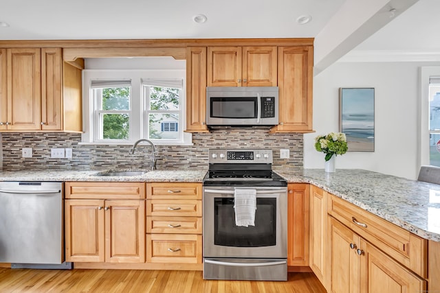 435 Lenox Rd, Fairfield, CT 06825 - kitchen featuring stainless steel appliances, a sink, a peninsula, crown molding, and tasteful backsplash