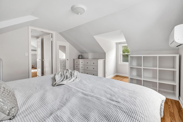 435 Lenox Rd, Fairfield, CT 06825 - bedroom featuring wood finished floors, a wall mounted AC, and lofted ceiling