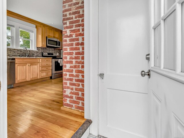 435 Lenox Rd, Fairfield, CT 06825 - kitchen with stainless steel appliances, a sink, tasteful backsplash, light wood-type flooring, and light stone countertops