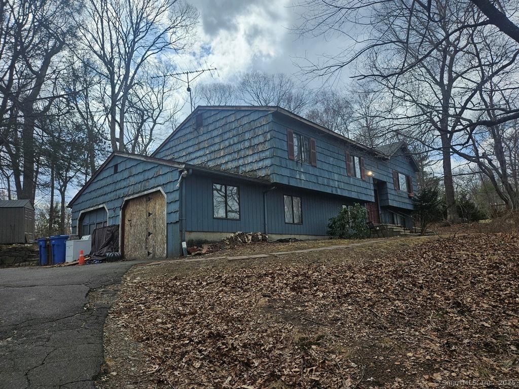 view of property exterior with aphalt driveway