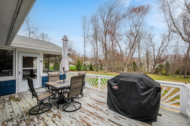 wooden terrace with grilling area and outdoor dining area