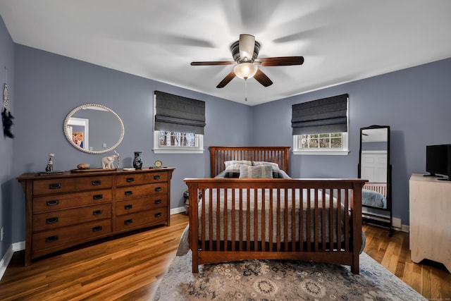 bedroom featuring baseboards, a ceiling fan, and wood finished floors