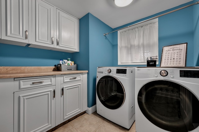 washroom featuring separate washer and dryer, cabinet space, and light tile patterned floors