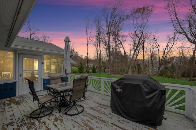 wooden terrace with area for grilling and outdoor dining space