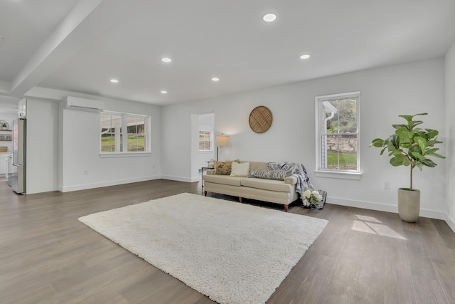 living area with plenty of natural light, dark wood-style floors, recessed lighting, and baseboards