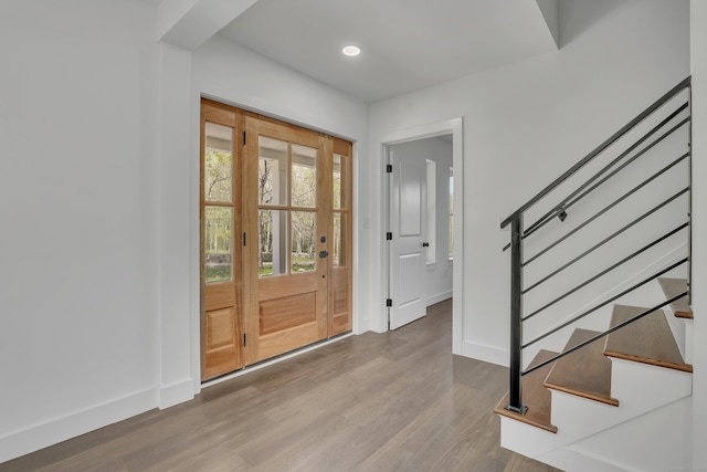 entryway featuring stairs, wood finished floors, baseboards, and recessed lighting
