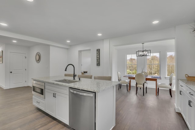 kitchen featuring a sink, appliances with stainless steel finishes, dark wood finished floors, recessed lighting, and white cabinets