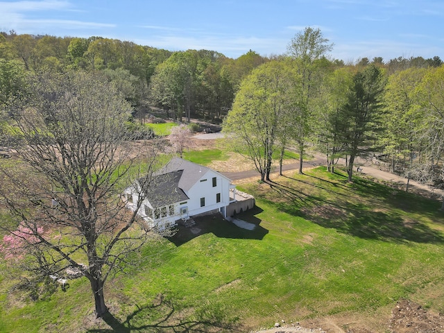 view of subject property featuring a heavily wooded area