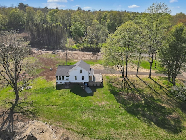 view of subject property featuring a heavily wooded area