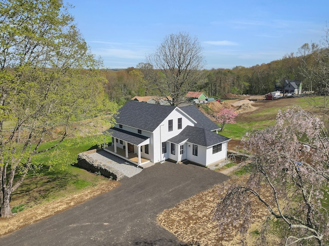 view from above of property with a heavily wooded area