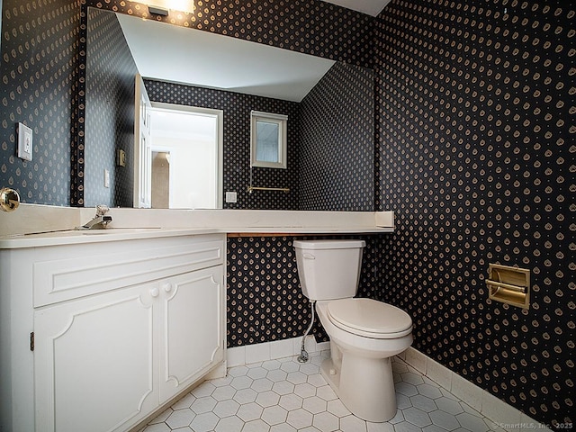 bathroom featuring wallpapered walls, tile patterned floors, vanity, and toilet