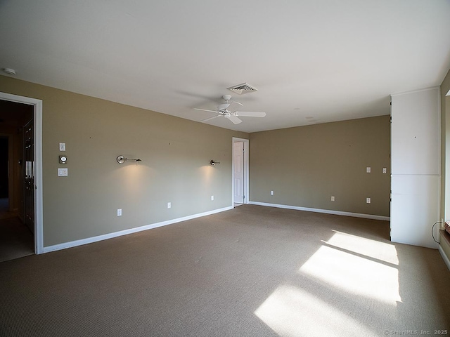 spare room featuring ceiling fan, baseboards, visible vents, and carpet