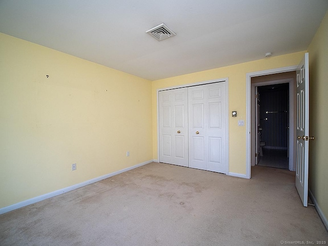 unfurnished bedroom with visible vents, carpet flooring, and baseboards