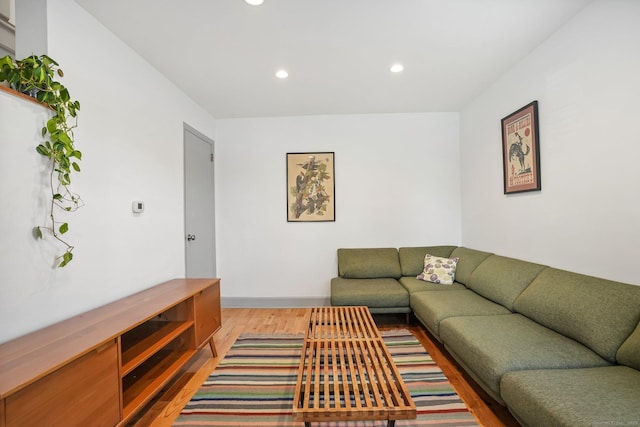 living area with recessed lighting and light wood finished floors