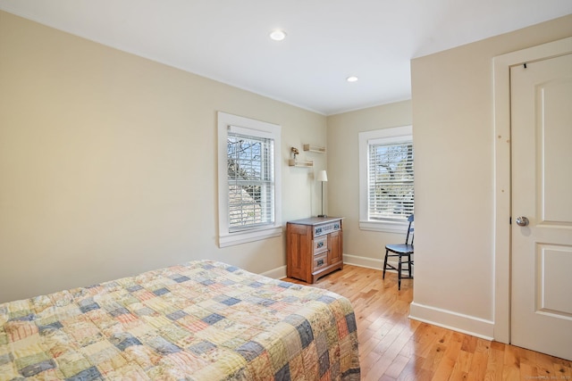 bedroom with recessed lighting, multiple windows, light wood-style flooring, and baseboards