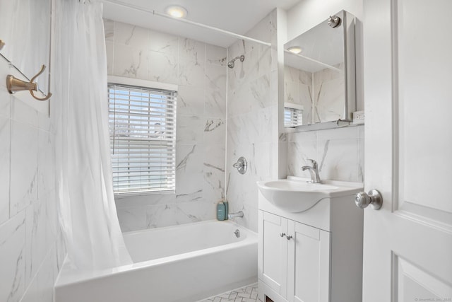 bathroom featuring shower / bath combo, tile walls, and vanity