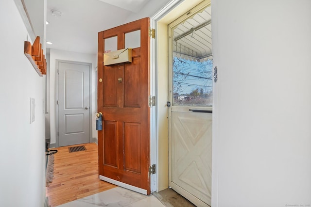 entryway with visible vents, recessed lighting, and marble finish floor