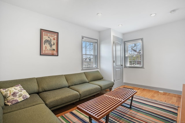living area with baseboards, recessed lighting, and wood finished floors