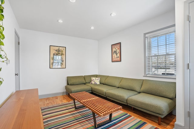 living area with recessed lighting, wood finished floors, and baseboards