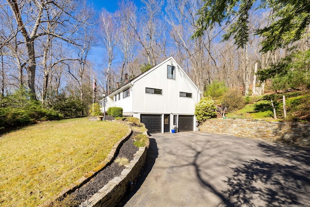 206 New Rd, Avon, CT 06001 - view of property exterior featuring a lawn, aphalt driveway, and a garage