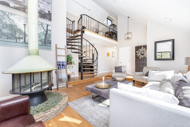 206 New Rd, Avon, CT 06001 - living area with baseboards, wood finished floors, high vaulted ceiling, and stairs
