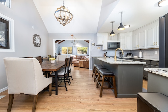 206 New Rd, Avon, CT 06001 - dining area with light wood-type flooring, an inviting chandelier, and lofted ceiling
