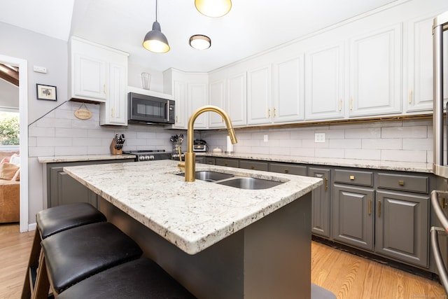 206 New Rd, Avon, CT 06001 - kitchen with light wood-type flooring, decorative backsplash, gray cabinetry, and a sink