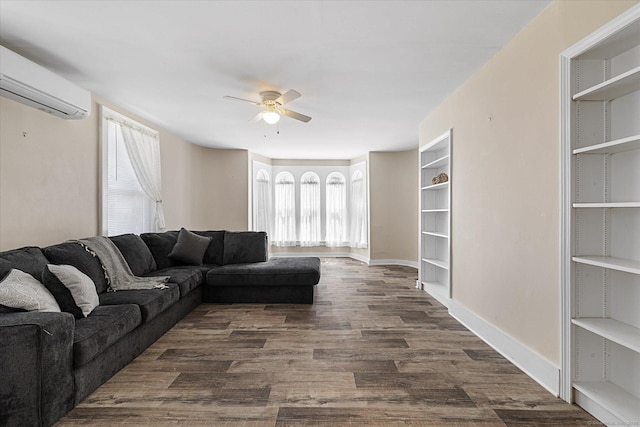 living room featuring ceiling fan, a wall mounted AC, a healthy amount of sunlight, and dark wood-style floors