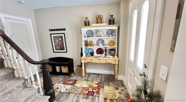 interior space with baseboards, stairs, and wood finished floors