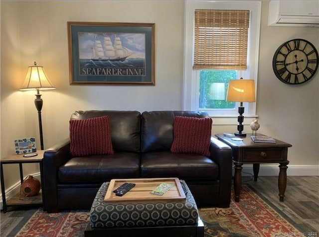 living area with baseboards, a wall mounted AC, and wood finished floors