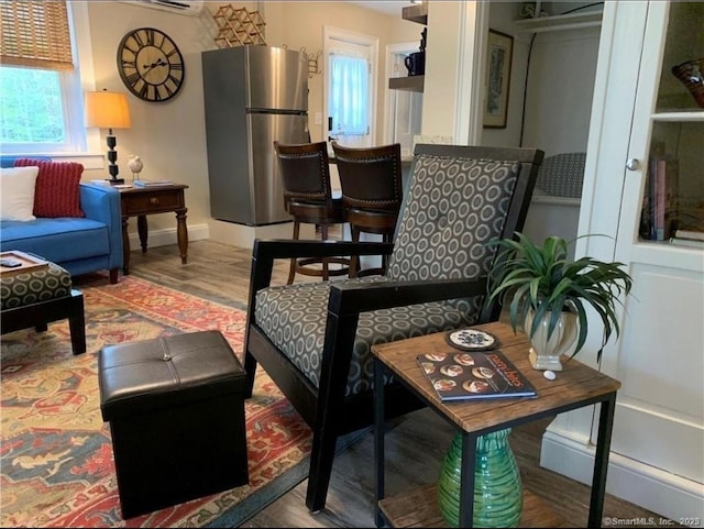 living room with baseboards and wood finished floors
