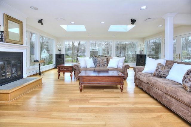 33 Pequot Trl, Westport, CT 06880 - living area featuring a skylight, a glass covered fireplace, light wood-type flooring, recessed lighting, and baseboard heating