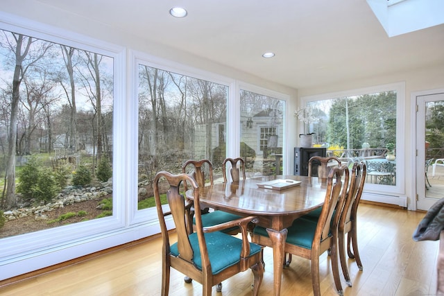 33 Pequot Trl, Westport, CT 06880 - sunroom featuring a wood stove, a skylight, and a baseboard heating unit