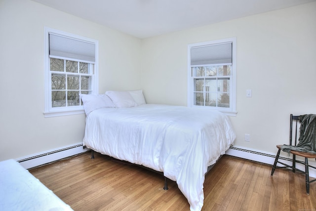 33 Pequot Trl, Westport, CT 06880 - bedroom with baseboard heating, multiple windows, and wood finished floors