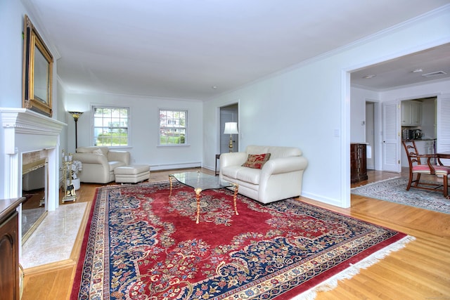 33 Pequot Trl, Westport, CT 06880 - living area with crown molding, wood finished floors, a premium fireplace, a baseboard heating unit, and baseboards