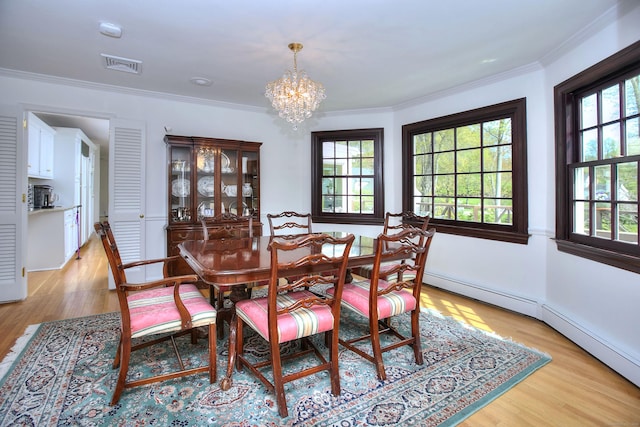 33 Pequot Trl, Westport, CT 06880 - dining area with a chandelier, light wood-type flooring, crown molding, and a baseboard heating unit