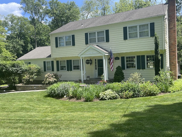33 Pequot Trl, Westport, CT 06880 - view of front of house with a chimney and a front yard