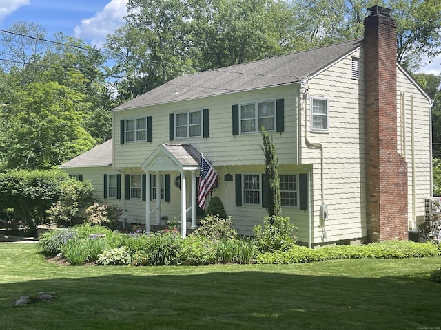 33 Pequot Trl, Westport, CT 06880 - view of front of home with a chimney, a front lawn, and a shingled roof
